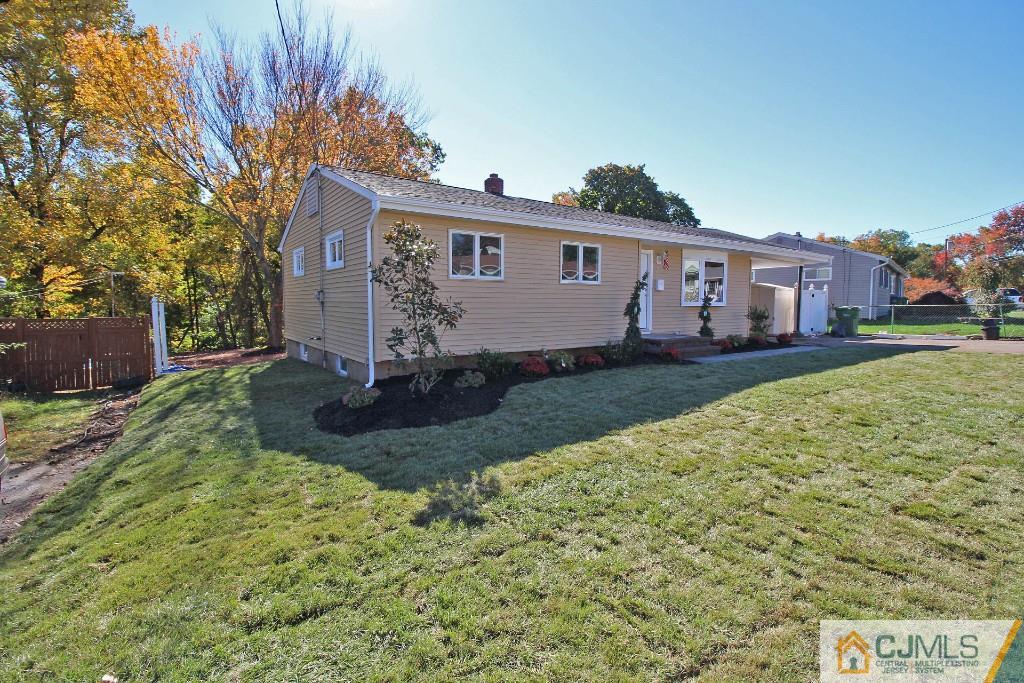 17 Brookside Road Edison, NJ 08817 - Photo 6 of 20 a front view of a house with a yard and garage