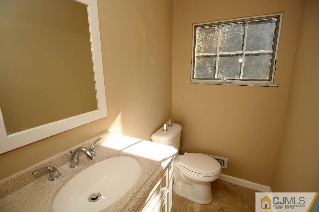17 Brookside Road Edison, NJ 08817 - Photo 8 of 20 a bathroom with a sink and a toilet