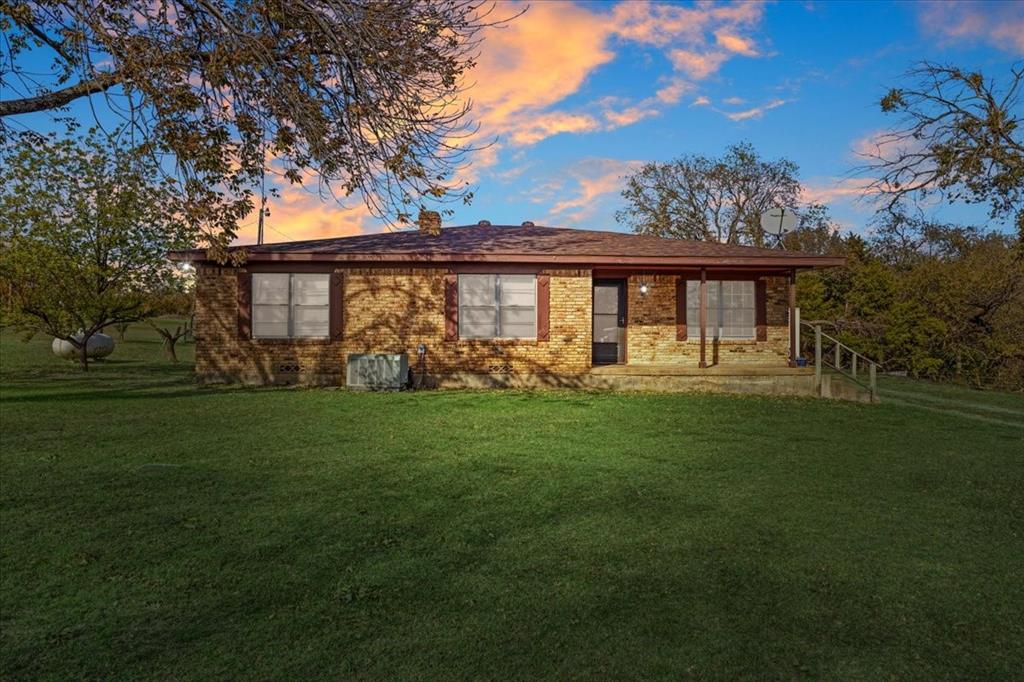 a front view of house with yard and green space