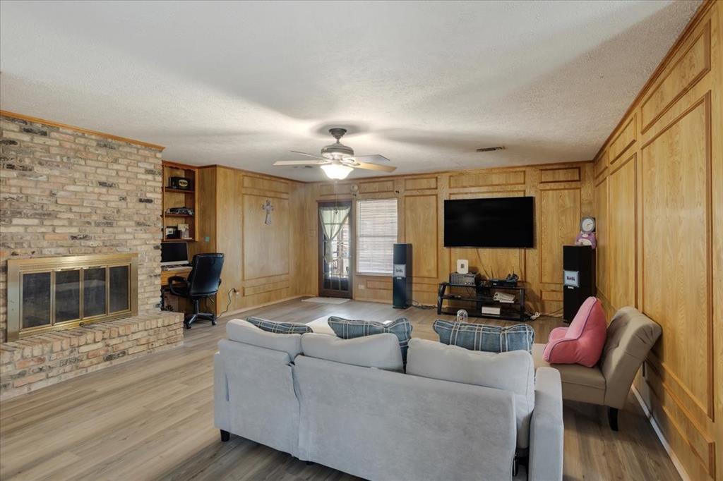567 Celtic Road Howe, TX 75459 - Photo 11 of 40 a living room with furniture and a flat screen tv