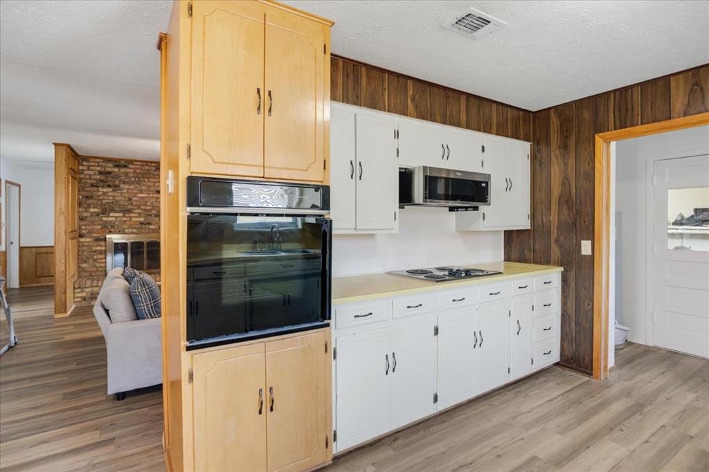 567 Celtic Road Howe, TX 75459 - Photo 15 of 40 a kitchen with stainless steel appliances a stove a microwave a sink and cabinets