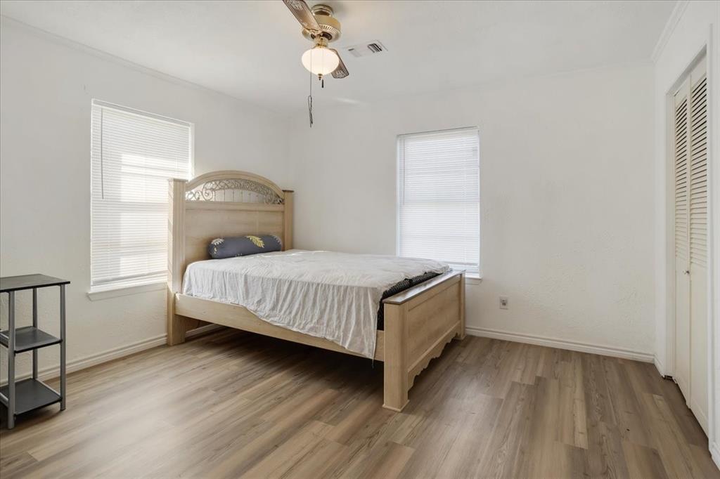 567 Celtic Road Howe, TX 75459 - Photo 23 of 40 a bedroom with a bed and wooden floor