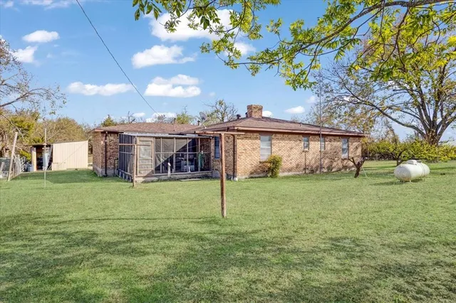 a view of a house with a backyard porch and garden