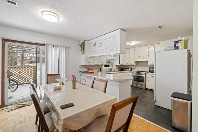 a kitchen with stainless steel appliances granite countertop a sink and a white cabinets
