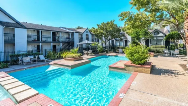 a view of a house with swimming pool and sitting area