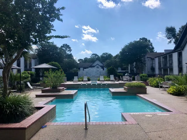 a view of a patio with swimming pool table and chairs
