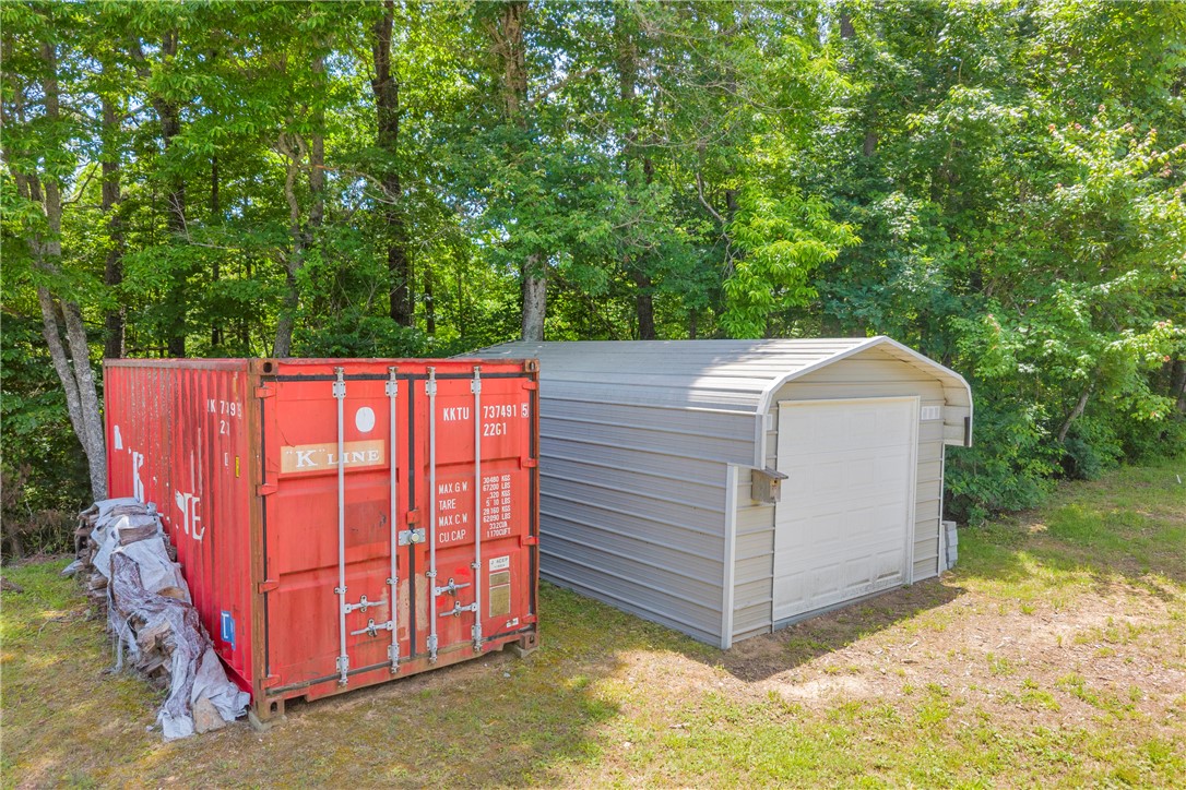 334 Lake Becky Road Mountain Rest, SC 29664 - Photo 24 of 46 A robust metal shed and an industrial storage container offer ample outdoor utility space.