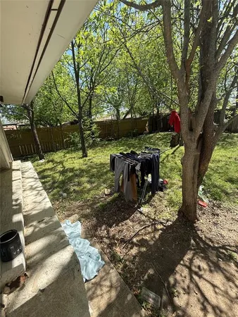 a view of a backyard with wooden fence