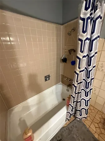 a bathroom with a bathtub and shower