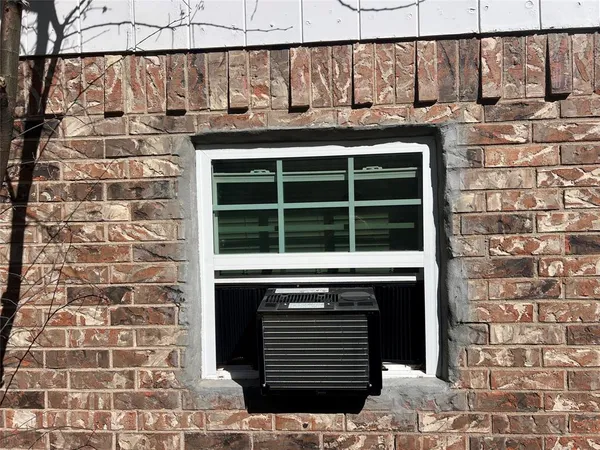 a front view of a building with a window and a shower