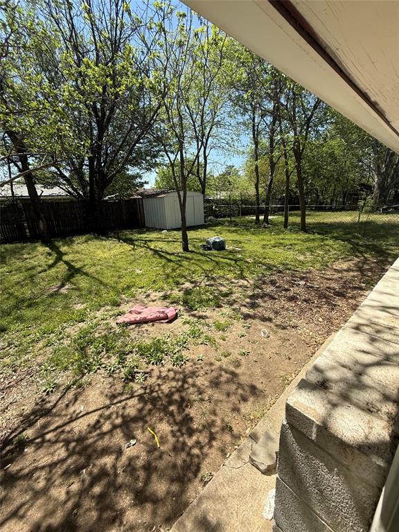 6036 Harrison Way Watauga, TX 76148 - Photo 21 of 39 Fenced backyard with a shed