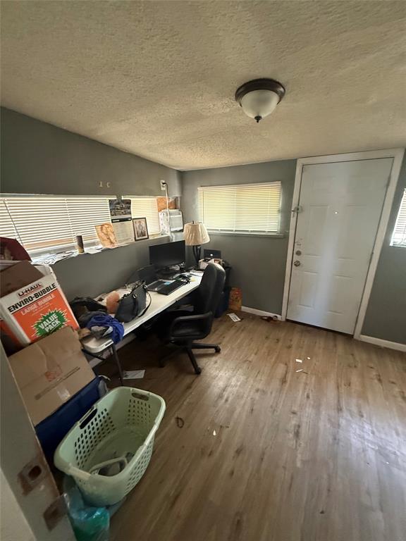 6036 Harrison Way Watauga, TX 76148 - Photo 31 of 39 Office space featuring a textured ceiling, light wood-type flooring, and healthy amount of natural light