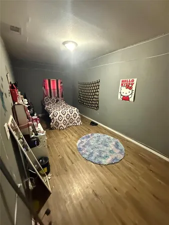 a bedroom with a bed closet and flat screen tv