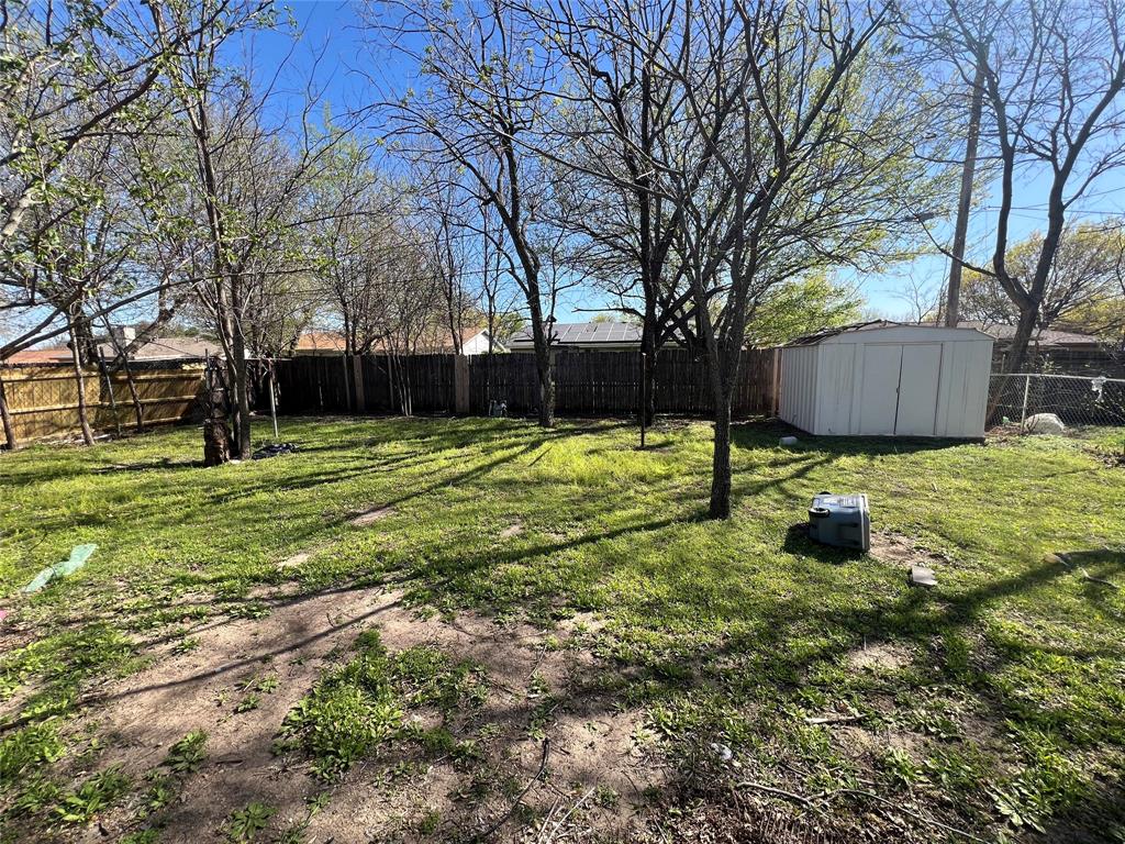 6036 Harrison Way Watauga, TX 76148 - Photo 4 of 39 Fenced backyard with a storage unit