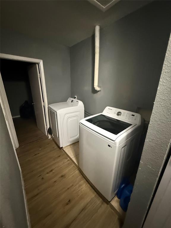 6036 Harrison Way Watauga, TX 76148 - Photo 7 of 39 Laundry room with light wood finished floors and washing machine and clothes dryer