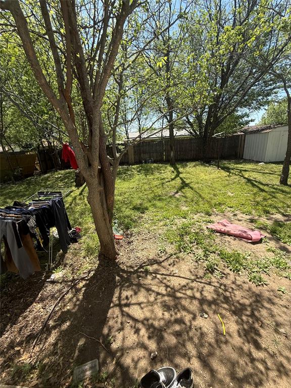 6036 Harrison Way Watauga, TX 76148 - Photo 10 of 39 Fenced backyard featuring a storage unit