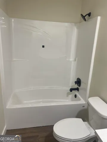 a bathroom with a toilet and a bathtub