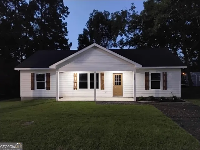 a front view of house with yard and green space
