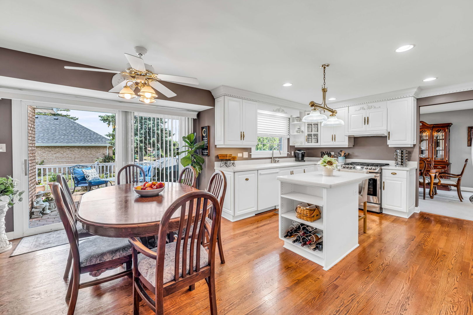 15624 Sunset Ridge Drive Orland Park, IL 60462 - Photo 11 of 37 a kitchen with stainless steel appliances kitchen island granite countertop a table chairs and a refrigerator