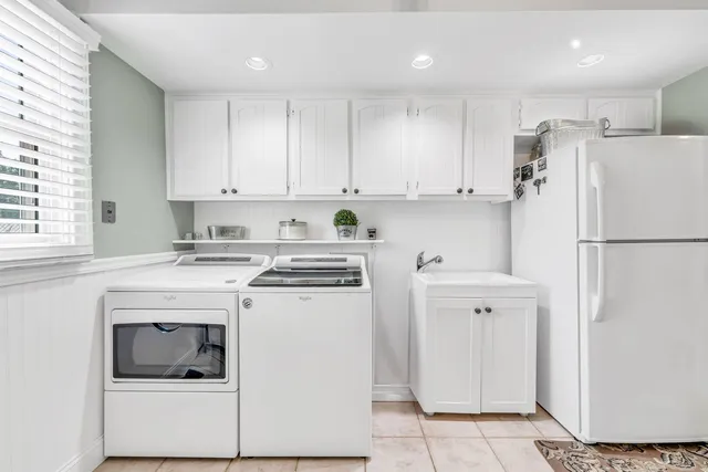 a kitchen with a refrigerator sink and cabinets