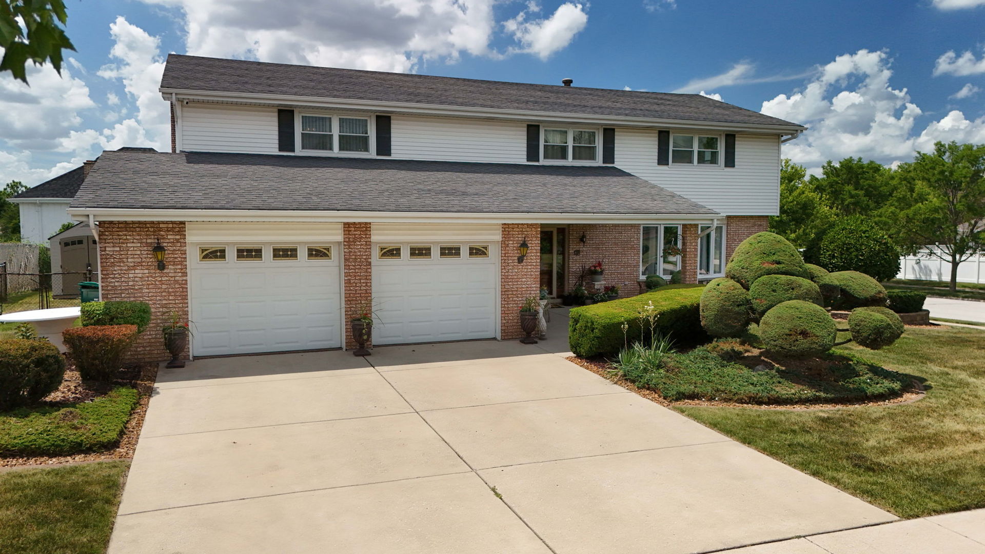 15624 Sunset Ridge Drive Orland Park, IL 60462 - Photo 3 of 37 a front view of a house with a yard and garage