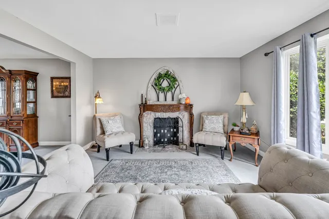 a living room with furniture and a fireplace
