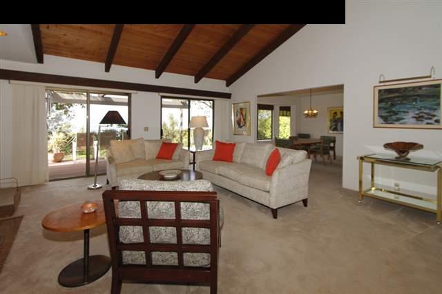 1365 Lower Kula Road Kula, HI 96790 - Photo 16 of 30 a living room with furniture a flat screen tv and a table