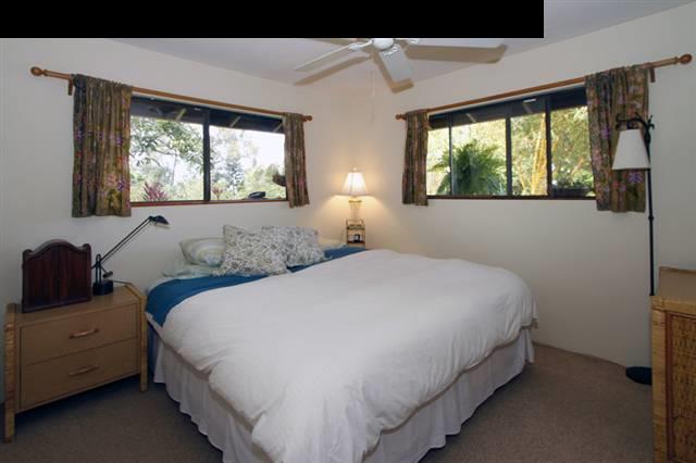 1365 Lower Kula Road Kula, HI 96790 - Photo 27 of 30 a bedroom with a bed and a large window