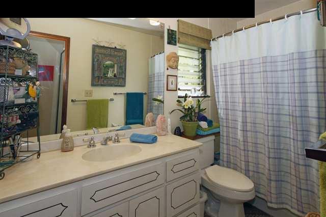 1365 Lower Kula Road Kula, HI 96790 - Photo 28 of 30 a bathroom with a granite countertop toilet sink and mirror