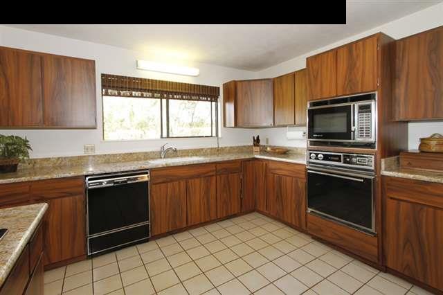 1365 Lower Kula Road Kula, HI 96790 - Photo 5 of 30 a kitchen with granite countertop a sink window and stainless steel appliances