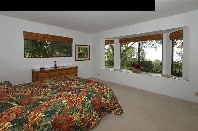 1365 Lower Kula Road Kula, HI 96790 - Photo 6 of 30 a bed sitting in a bedroom next to a window