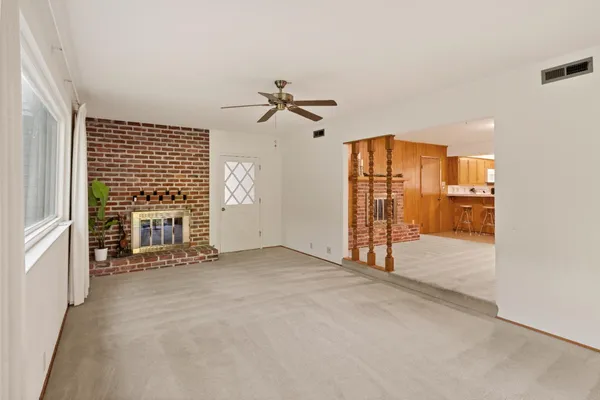 a view of an empty room with a fireplace