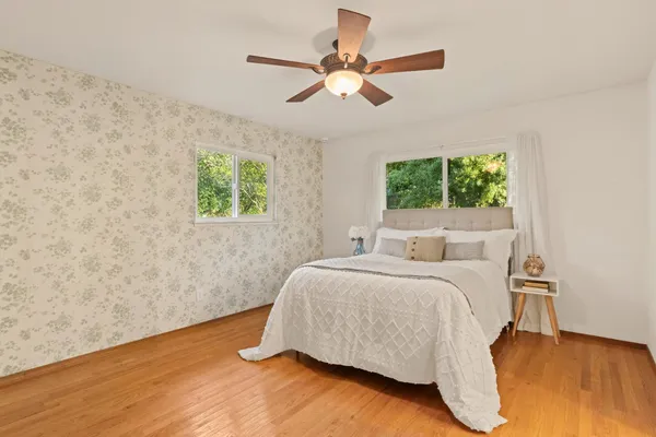 a bedroom with a bed and a window