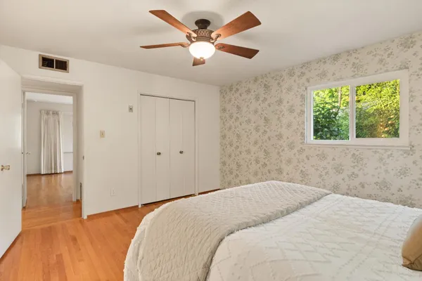 a bedroom with a large bed and a chandelier