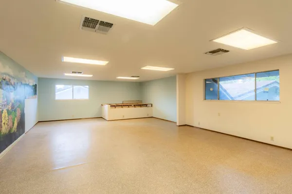 an empty room with a empty space and windows