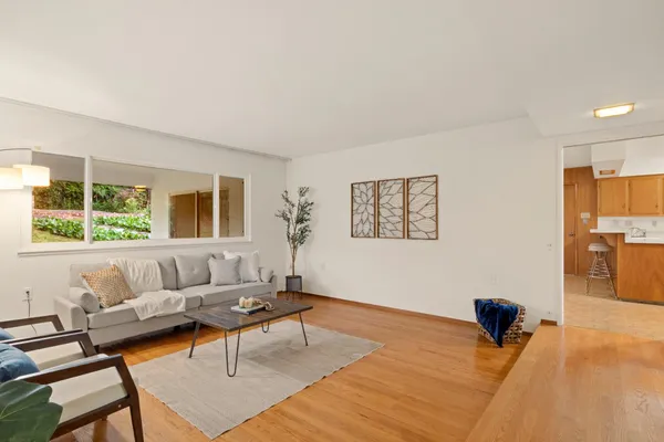 a bedroom with furniture and a large window