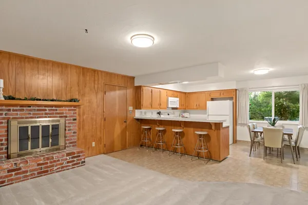 a kitchen with a stove a sink and a fireplace