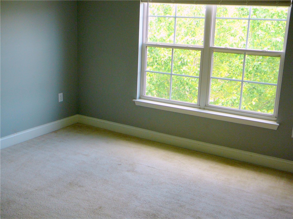 131 Lookover Drive Anderson, SC 29621 - Photo 10 of 18 A quiet bedroom offers serene views of lush foliage through a wide window.