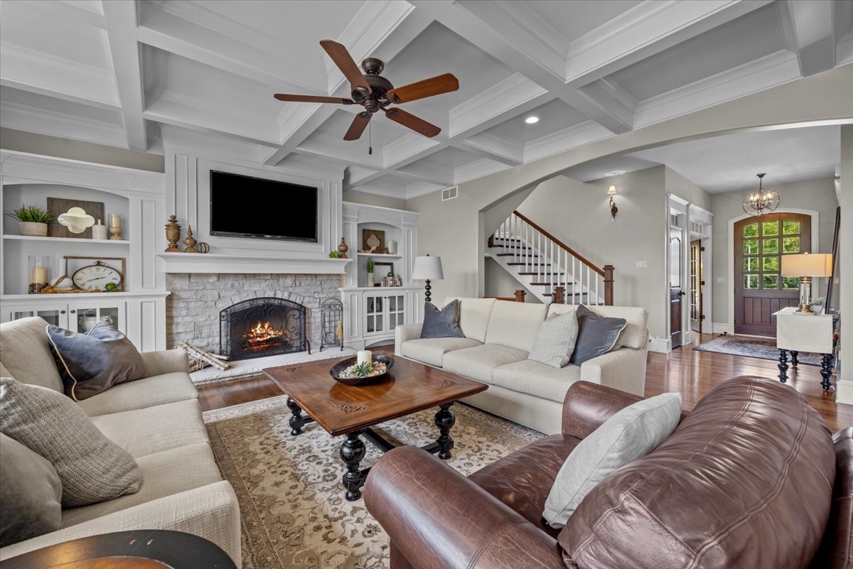 754 Wild Ginger Road Sugar Grove, IL 60554 - Photo 11 of 52 a living room with furniture a flat screen tv and a fireplace