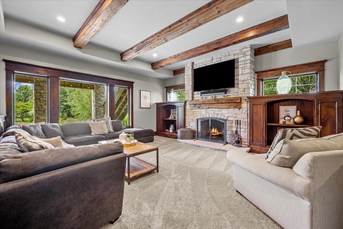 754 Wild Ginger Road Sugar Grove, IL 60554 - Photo 29 of 52 a living room with furniture a flat screen tv and a fireplace
