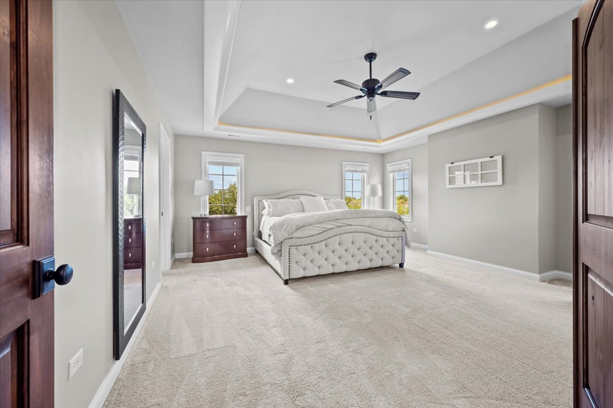 754 Wild Ginger Road Sugar Grove, IL 60554 - Photo 33 of 52 a spacious bedroom with a bed and ceiling fan