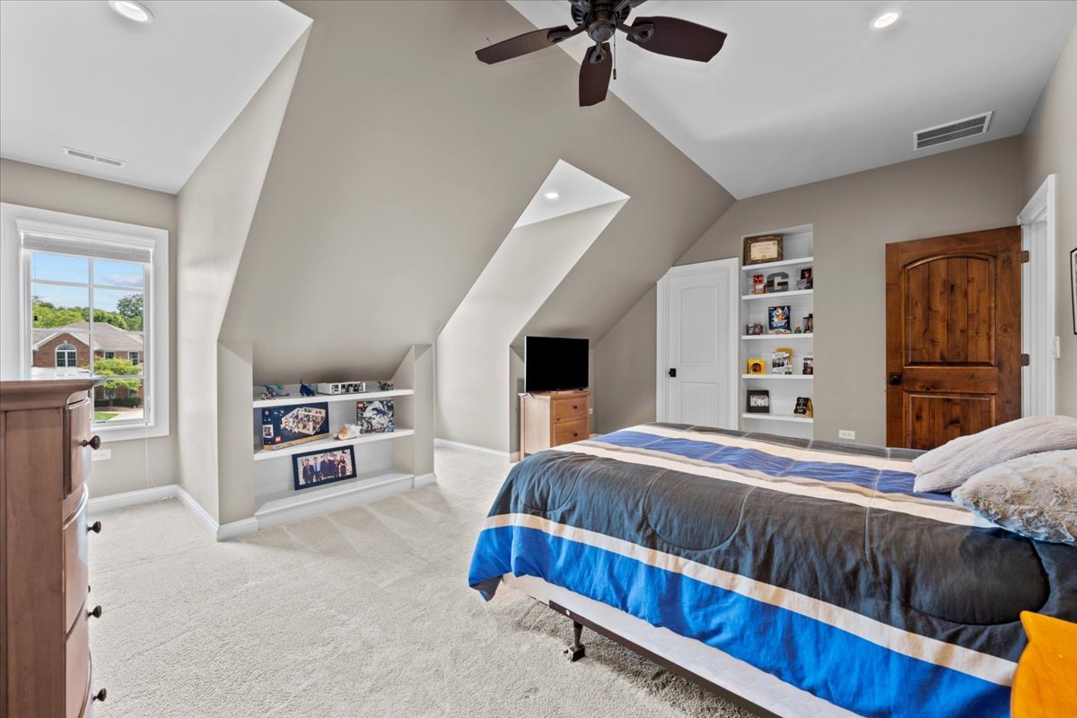 754 Wild Ginger Road Sugar Grove, IL 60554 - Photo 38 of 52 a bedroom with a bed and a book shelf