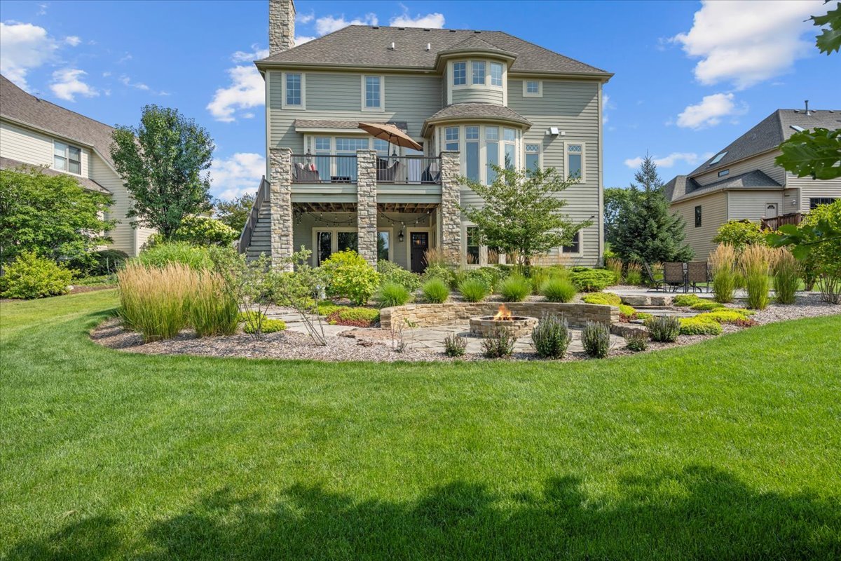 754 Wild Ginger Road Sugar Grove, IL 60554 - Photo 42 of 52 a front view of a house with a yard table and chairs