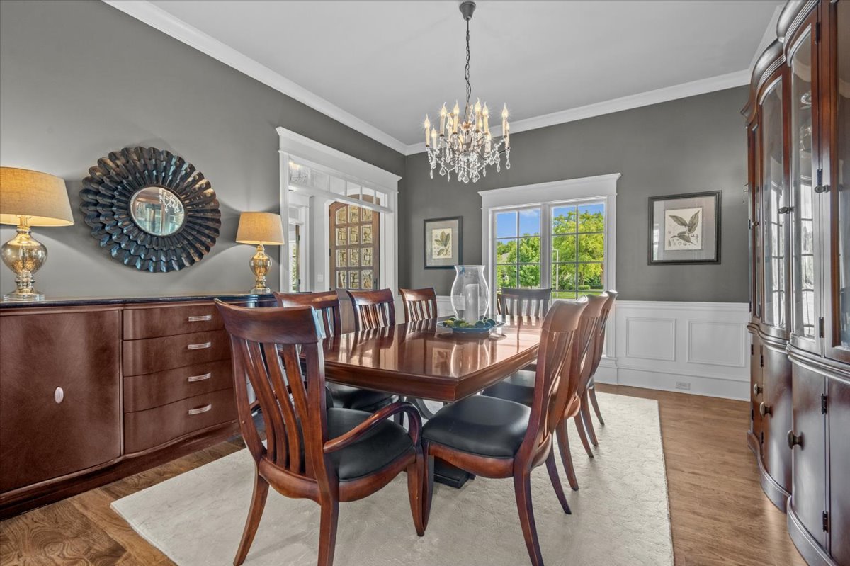 754 Wild Ginger Road Sugar Grove, IL 60554 - Photo 6 of 52 a view of a dining room with furniture a chandelier and wooden floor