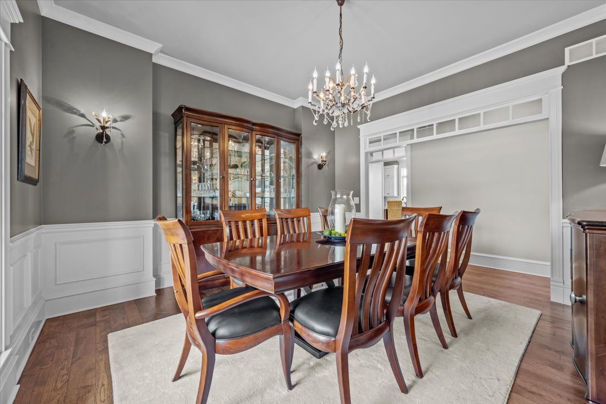 754 Wild Ginger Road Sugar Grove, IL 60554 - Photo 7 of 52 a view of a dining room with furniture a chandelier and wooden floor