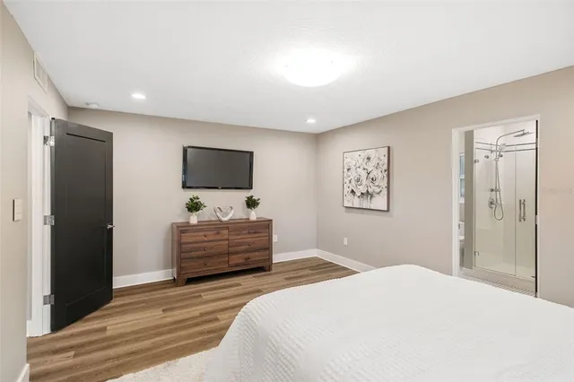 a bedroom with a bed and a flat screen tv