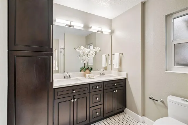 a bathroom with a sink vanity granite and a mirror