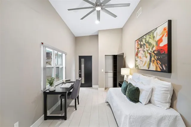 a bedroom with a bed and a painting on the wall