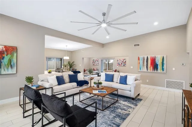 a living room with fireplace furniture and a rug