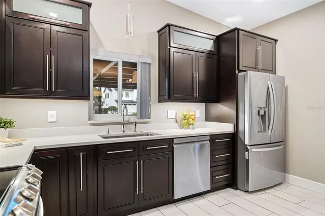 a kitchen with a sink appliances and cabinets
